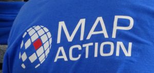 A close up of the MapAction logo on the back of a tee shirt worn by a volunteer