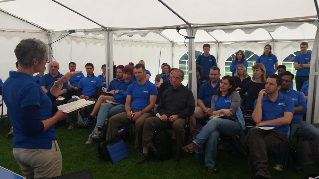 MapAction's Chief Executive presents to volunteers in a marquee during a training exercise